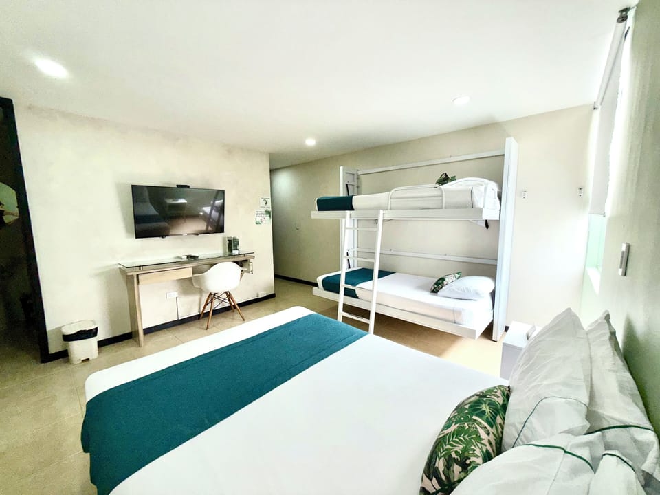 Standard Quadruple Room, Multiple Beds | Minibar, in-room safe, desk, laptop workspace