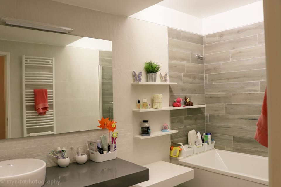 Bathroom 3 with Bath and shower above with glass screen.