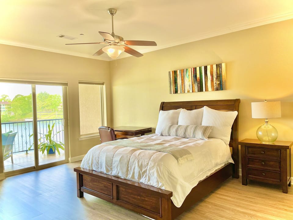 The spacious master bedroom has private access to the balcony