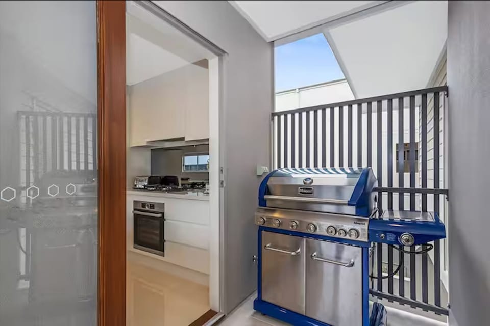 Easy kitchen access to an 8-burner BBQ with pizza oven.