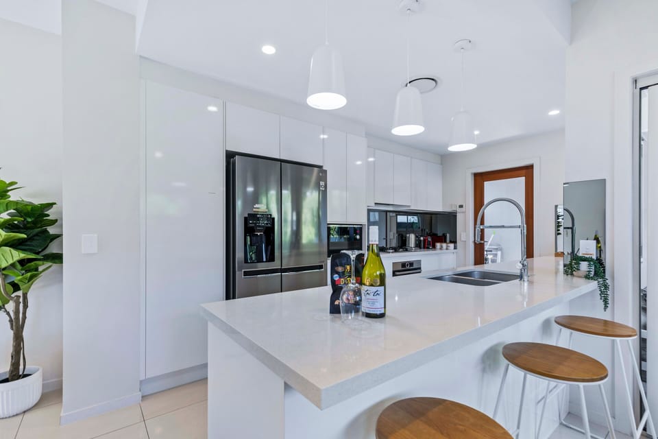 White island kitchen with Bosch appliances, gas cooking and fridge.
