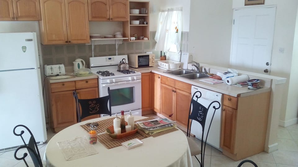 Comfort Room, Multiple Beds, Non Smoking | Private kitchen | Full-size fridge, microwave, stovetop, cookware/dishes/utensils