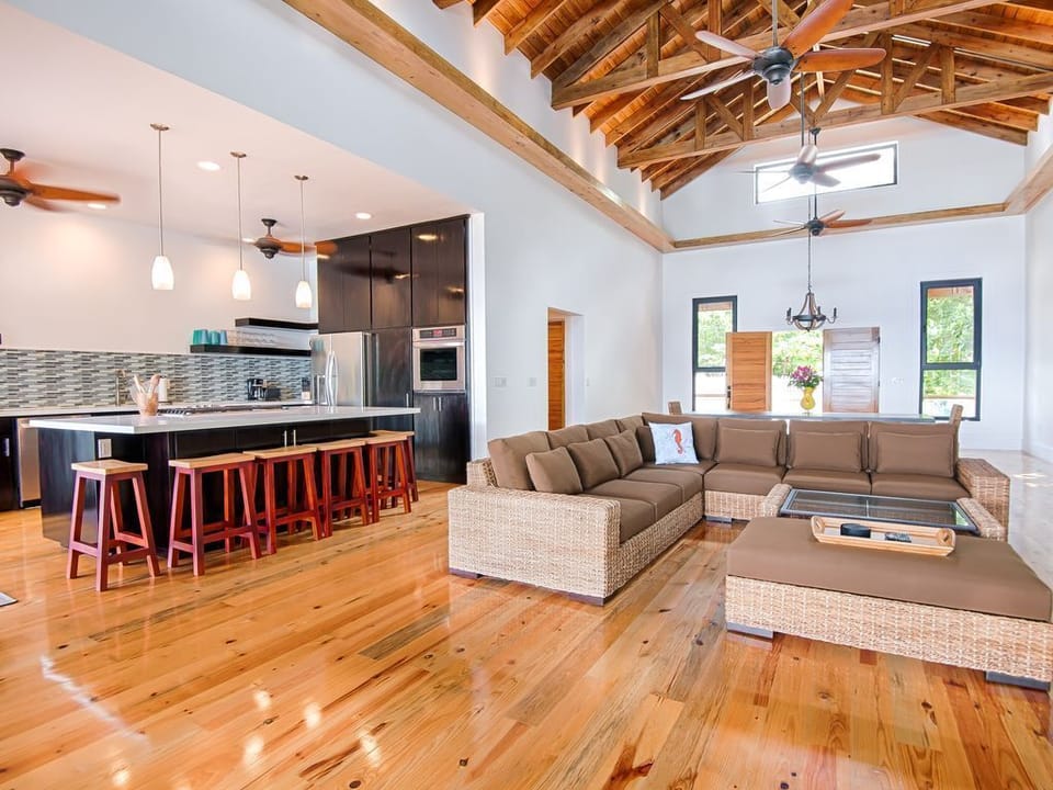 The Great Room 🌊

Soaring ceilings and glass walls offer panoramic ocean views. The space flows seamlessly onto the deck, blending indoor luxury with island breezes. Plush seating and high-end design make it the ultimate hub for sunset views. ✨