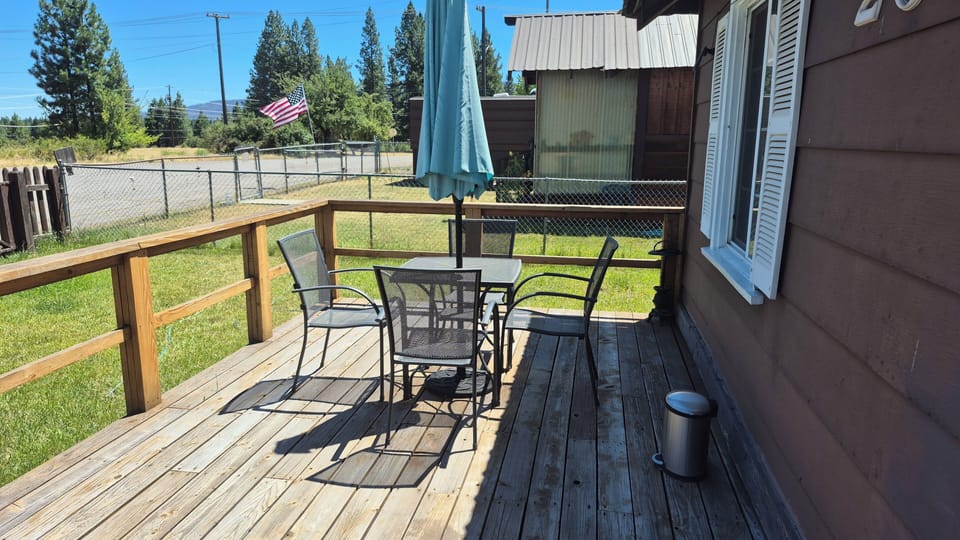 patio chairs and table on the front deck
