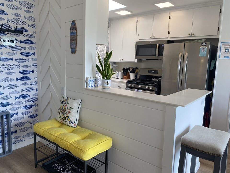 Your fully equipped kitchen features stainless steel appliances and a cheerful breakfast bar where you can sip morning coffee.