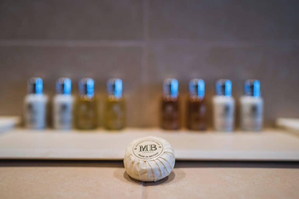 Designer toiletries, hair dryer, bathrobes, slippers