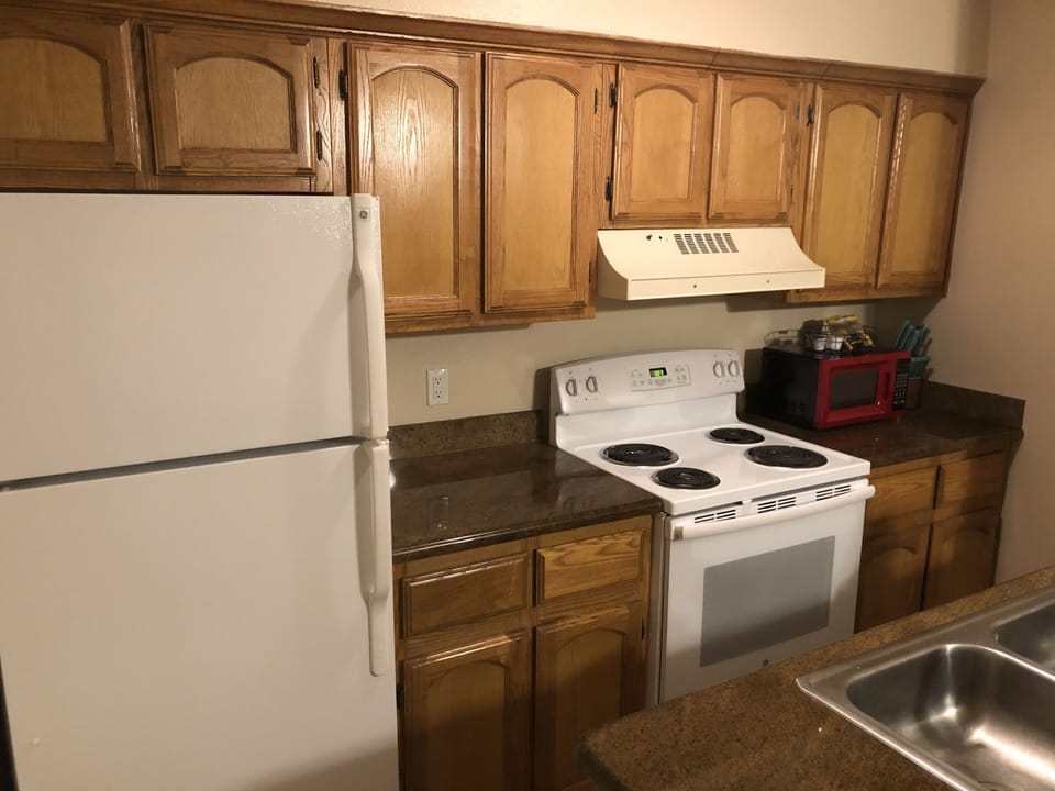 Galley style kitchen with granite counters.