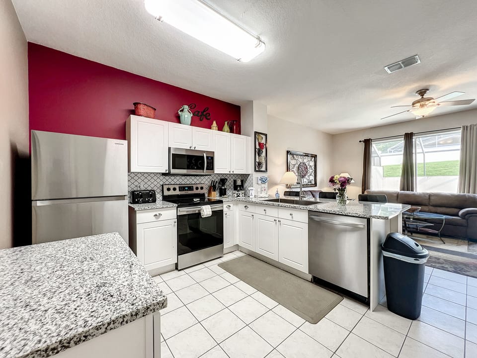 Fully equipped kitchen with stainless steel appliances and ample counter space.