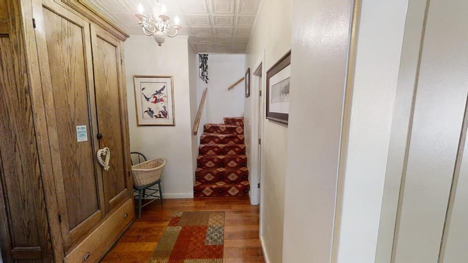 Step into your welcoming entryway, where warm hardwood floors and charming vintage details set the tone for a cozy, relaxing stay.