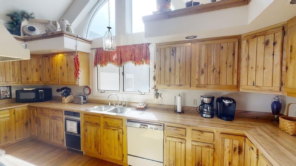 This inviting kitchen welcomes you with warm knotty pine cabinetry, spacious counters, and all the appliances you need to prepare home-cooked meals during your stay.