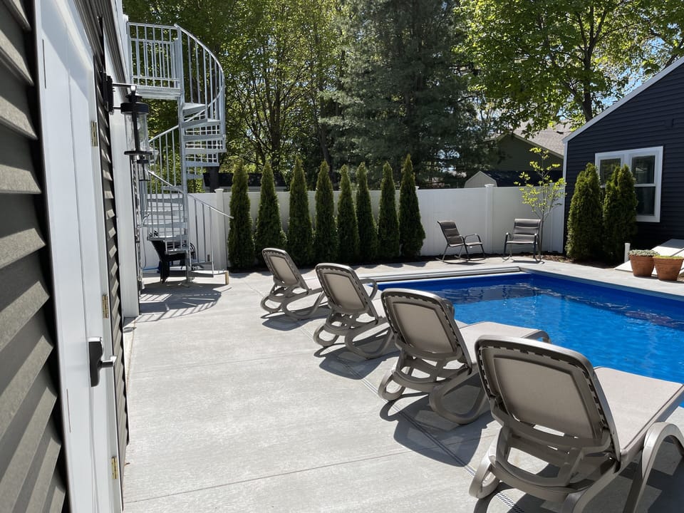 pool area and spiral staircase to lounge deck