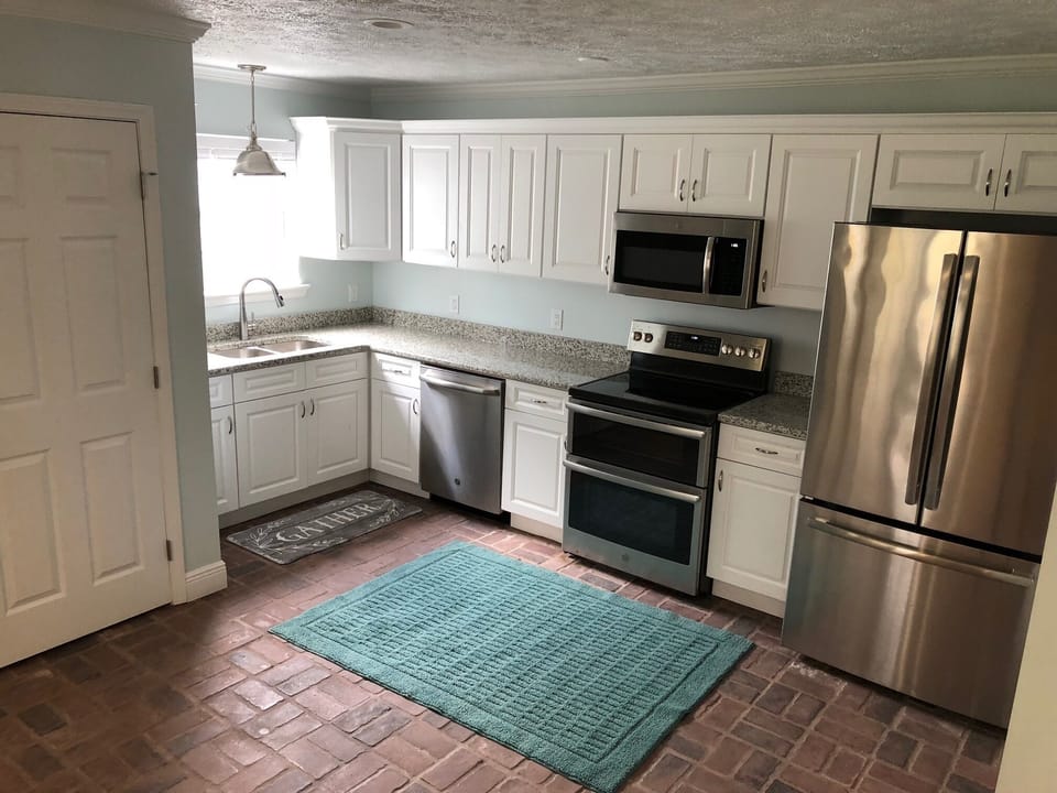 Spacious kitchen with real brick floors. 