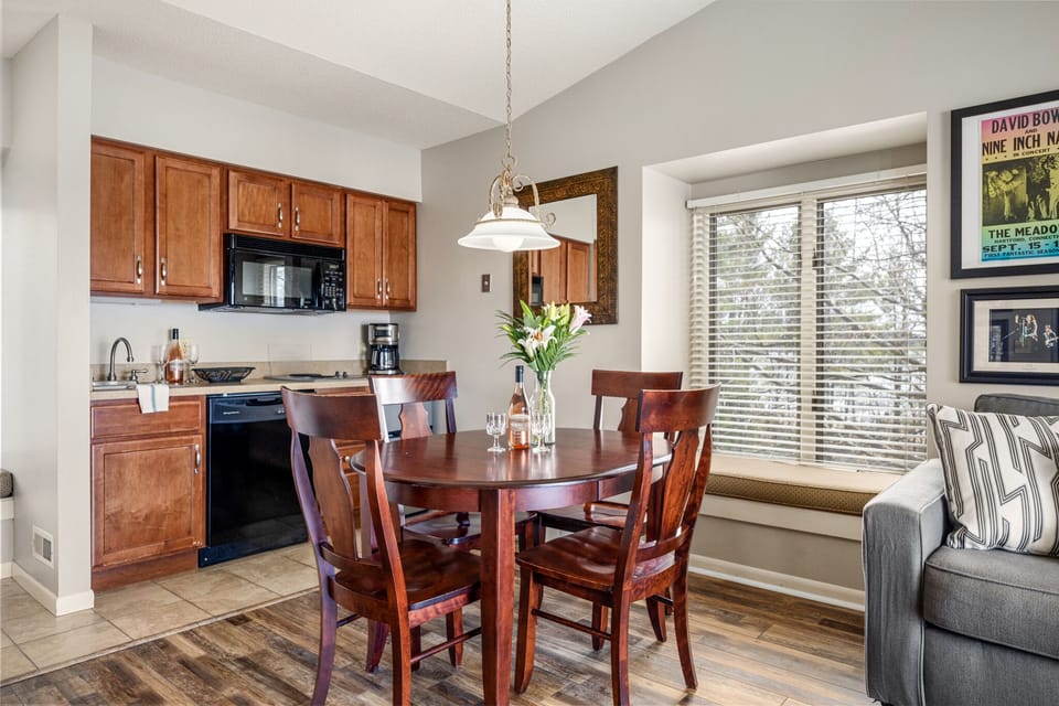 The dining area and kitchen feature a window, providing a fresh and airy ambiance, along with a mini fridge for your convenience.