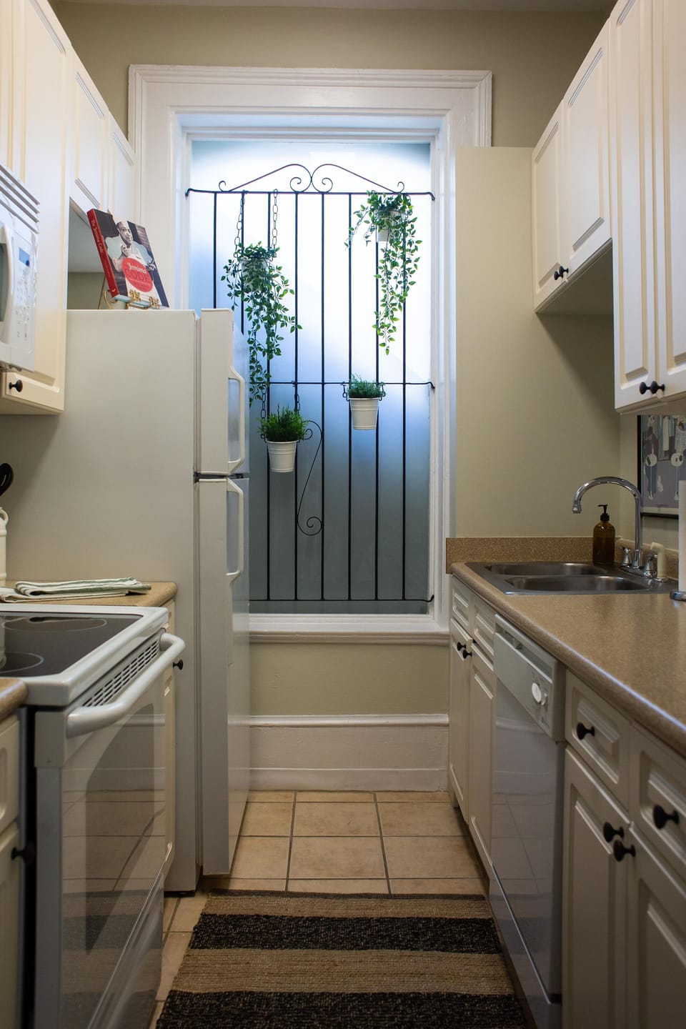 Cute galley kitchen is well stocked for meal prep. 