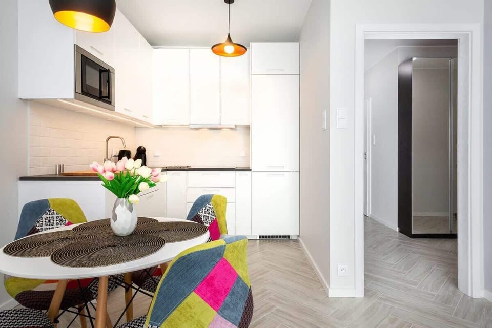 Kitchenette with dining table with round top. 