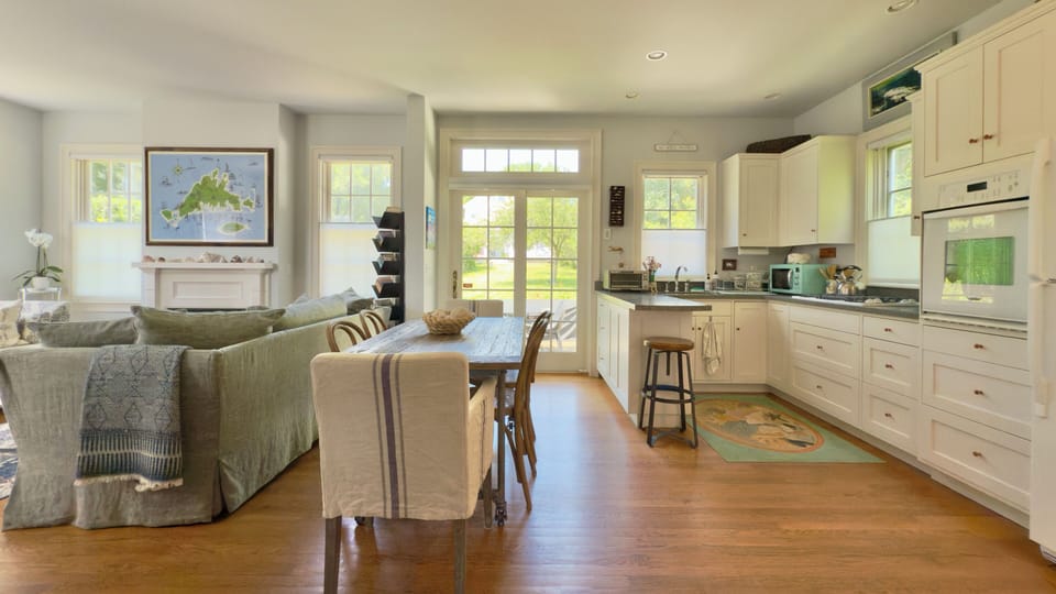 Dining area and kitchen looking towards back patio with sliding doors