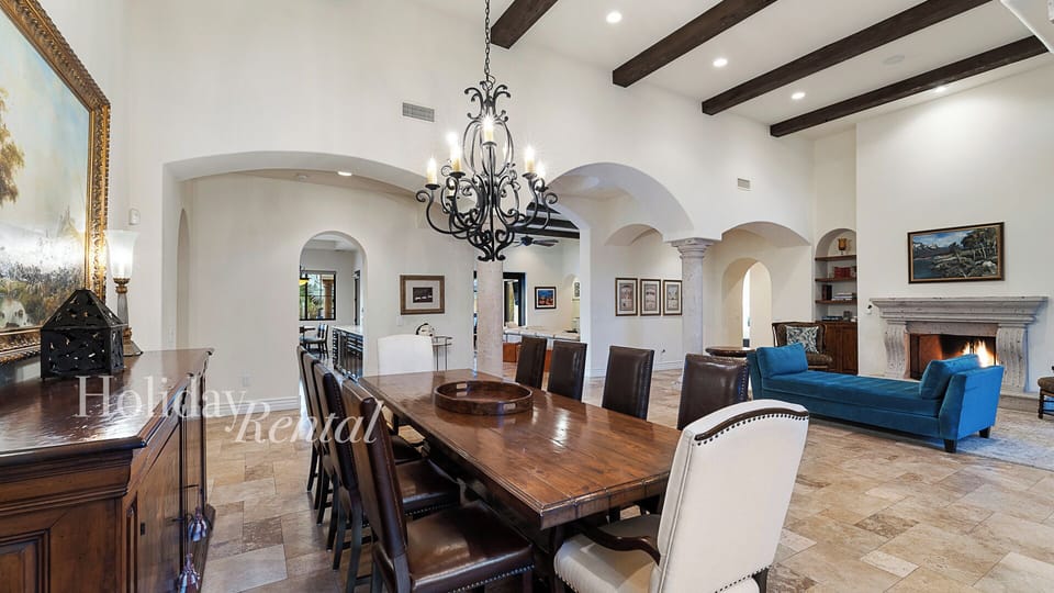 Dine in style, chandelier-lit table seats 10 with timeless charm.