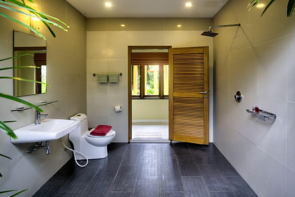 Spacious Bathroom 1 with walk-in shower and large, separate bath tub