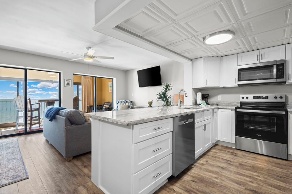 Gulf Tower 7D Kitchen into Living & Glass covered balcony w/ Gul