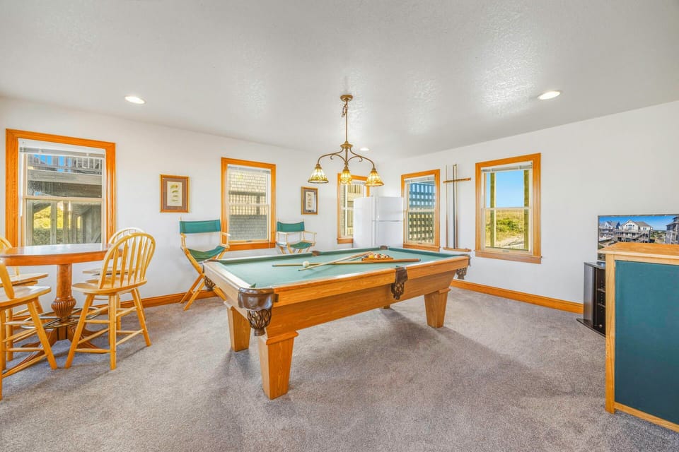 Challenge friends to a game in your private recreation room, featuring a professional pool table and cozy seating area.