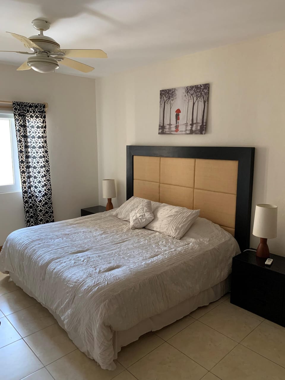 King size bed with big window and custom hardwood closet behind the photographer