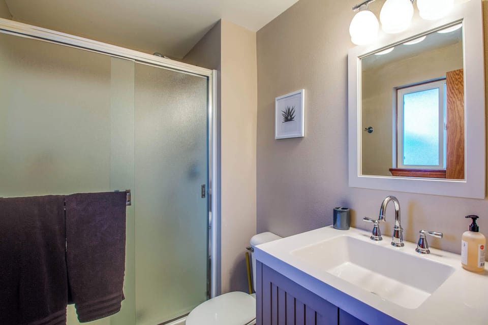 The master bathroom features a standing shower and lots of room under the vanity to store your bathroom necessities. 