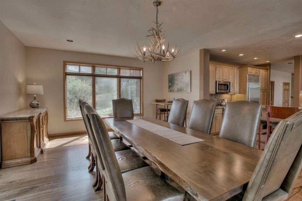 The table has enough room to sit 9 with an additional 8 seats around the kitchen island bar