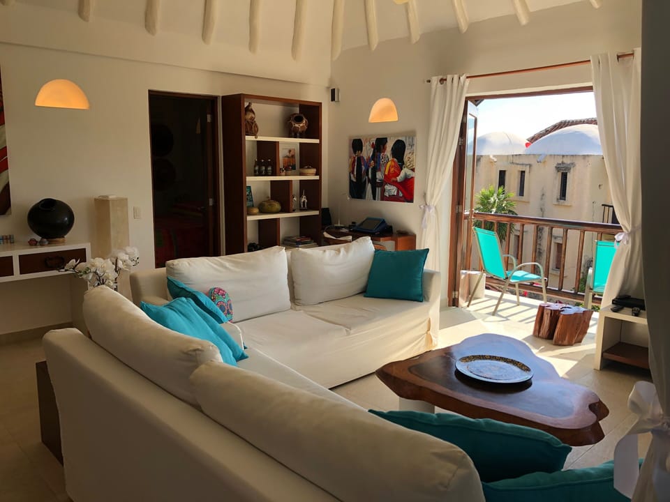Main living space. Kitchen on the left at the back and master bedroom thru door