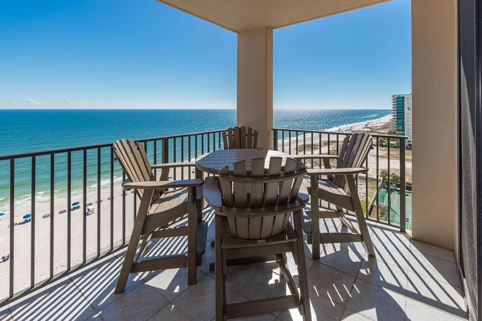 Relax at the outdoor table, enjoying panoramic views of the shimmering water and beach below