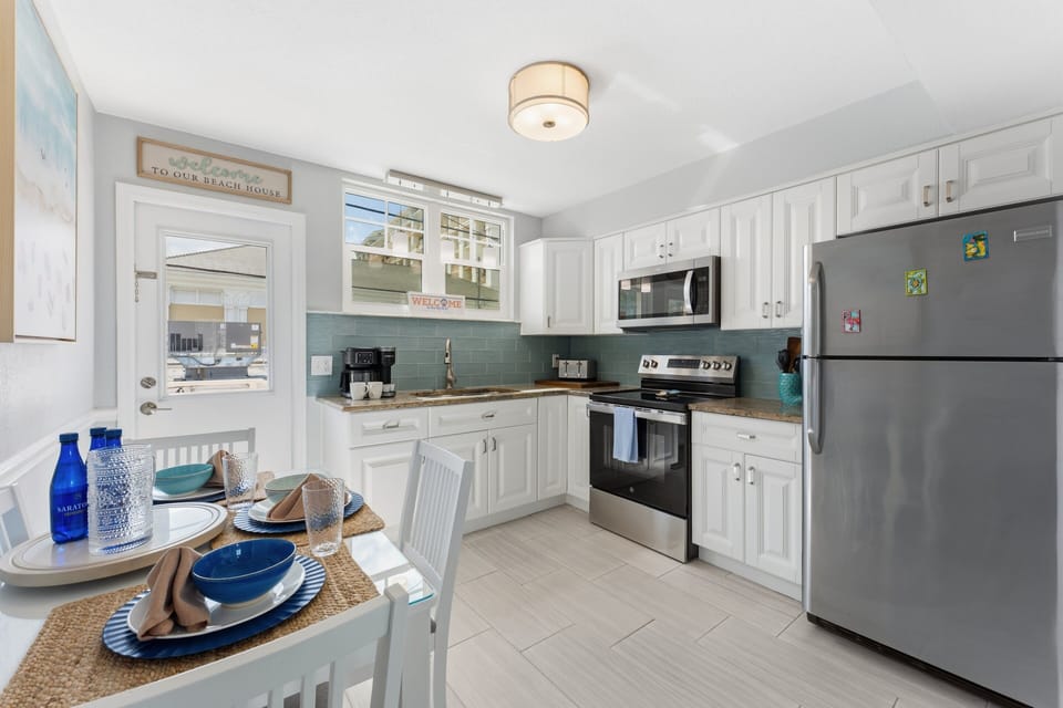 Our full kitchen Features stainless steel appliances including large fridge, stove, oven, blender and  microwave (Note: no dishwasher).