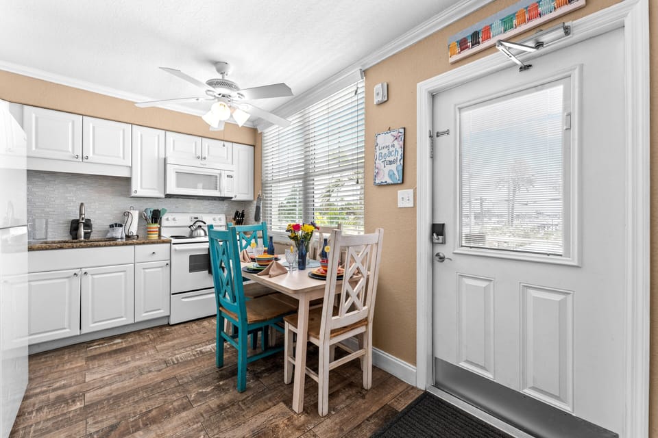 Beautiful dining area by the window, located between the living and kitchen spaces.