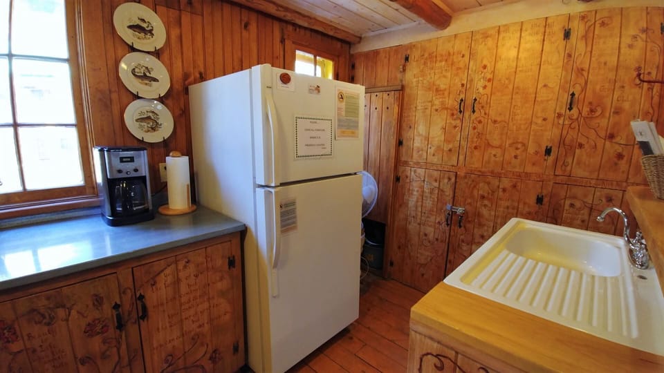 Step into your cozy, knotty-pine kitchen where rustic charm meets all the essentials. Warm wood surrounds you as you prepare meals and enjoy homey touches throughout your stay.