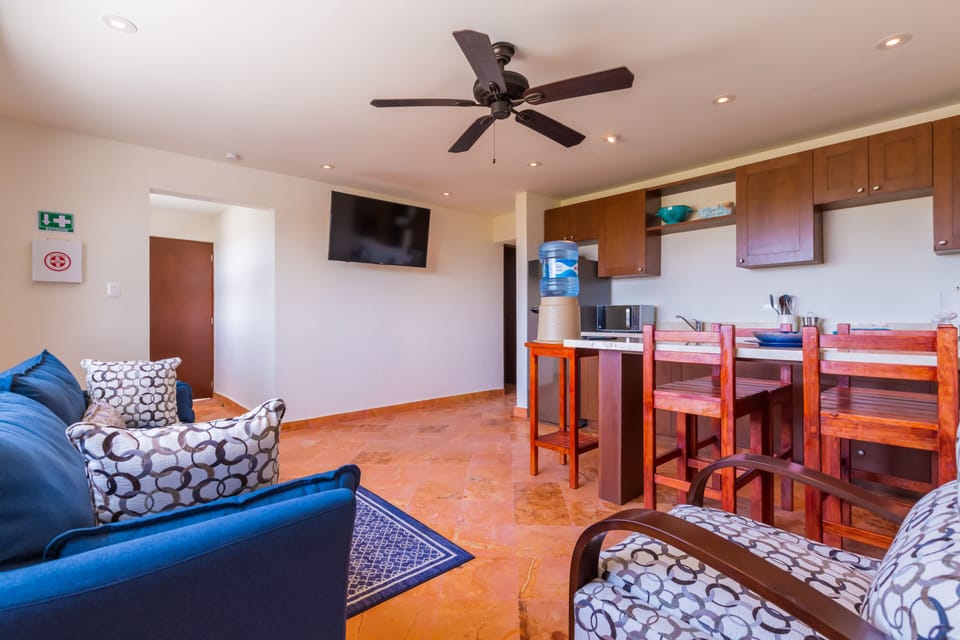 Living area with TV, full kitchen and kitchen bar