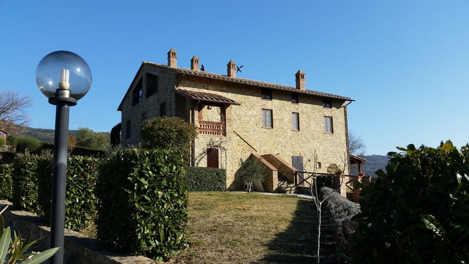 Front elevation and garden. Access via staircase and portico.