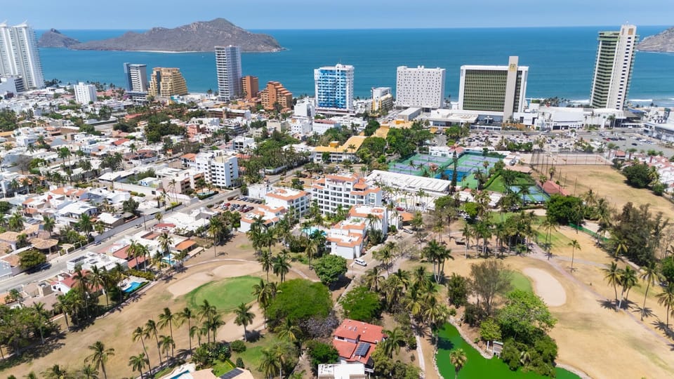 Drone shot of location off golf course, club house and beach access