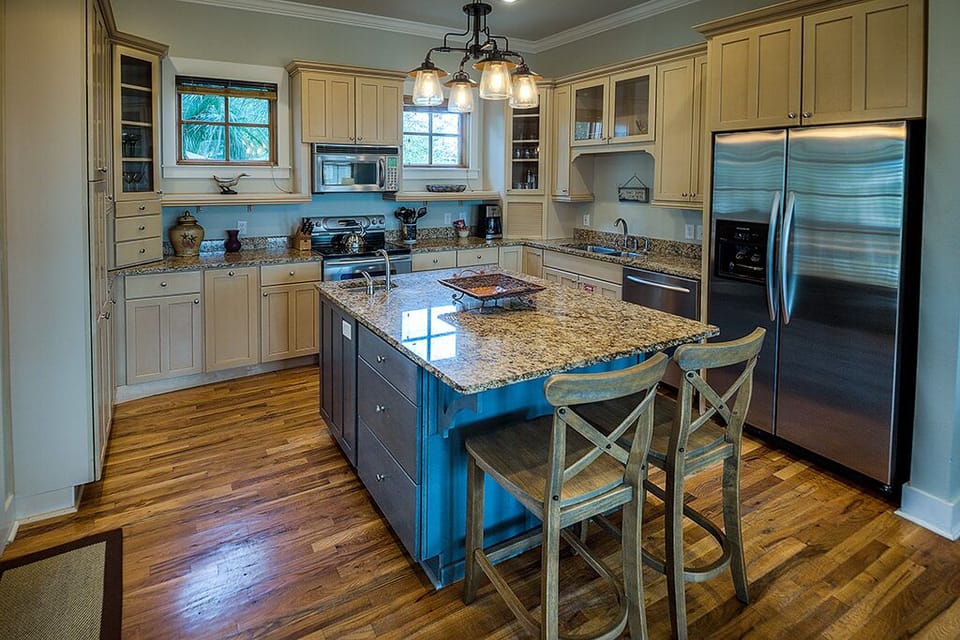 Kitchen Island, Stools, Microwave, Refrigerator, and Coffee Table.