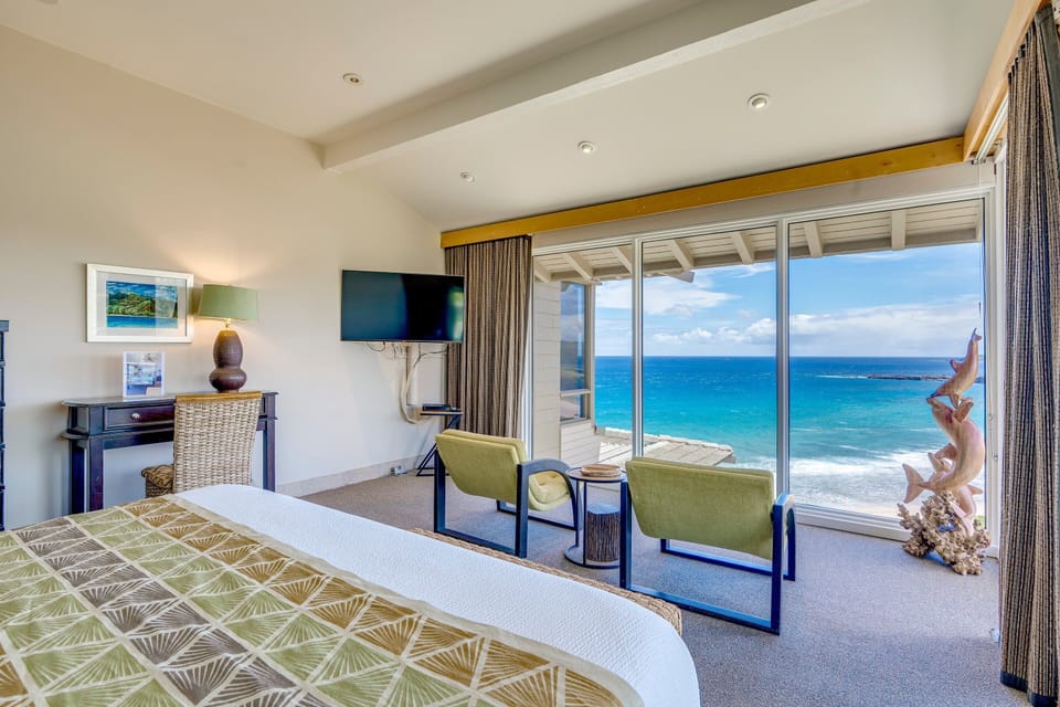 Amazing oceanfront bedroom with workspace.
