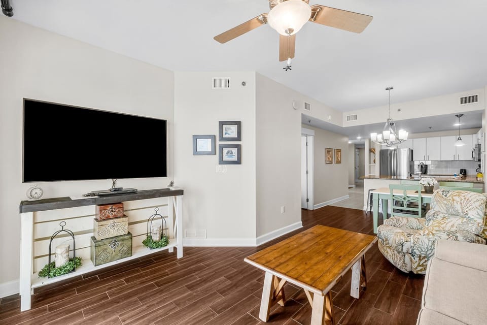 Living area with plenty of seating and a large, flat screen TV