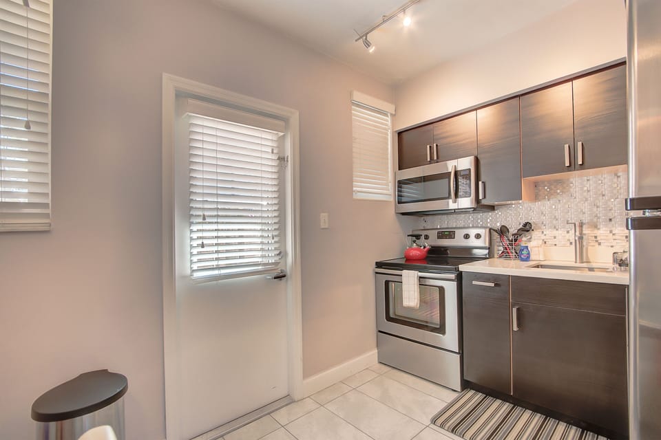 Kitchen: Features brand new stainless steel appliances including large fridge, stove, oven, microwave, coffee maker.