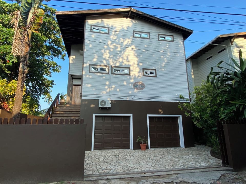 View of house from the road with gate open.