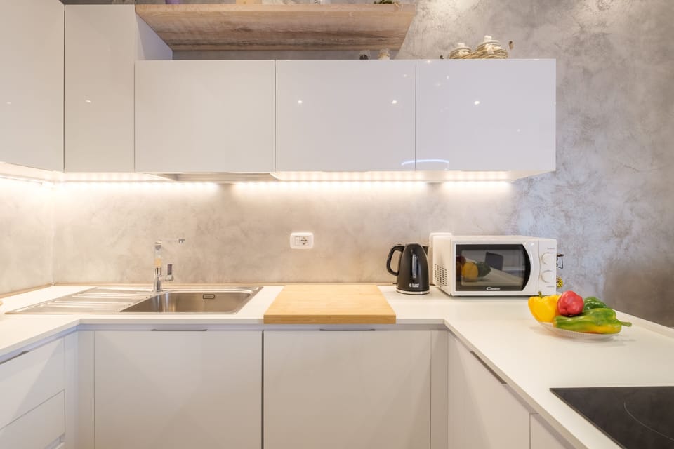 Deluxe Apartment, 1 Bedroom | Private kitchen | Full-size fridge, microwave, stovetop, coffee/tea maker