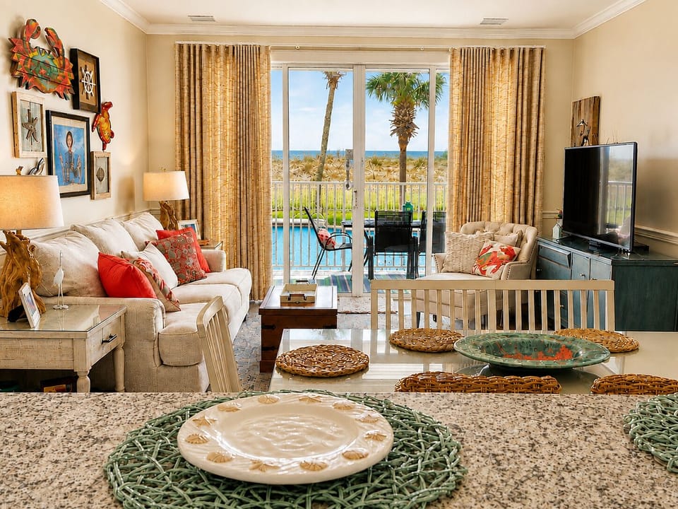 Open-concept living and dining with pool and Gulf views from the kitchen.