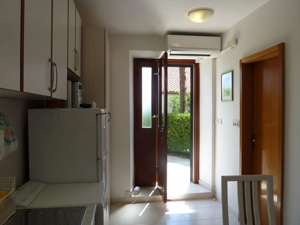 Entrance and kitchen of the apartment. The right door leads to bathroom