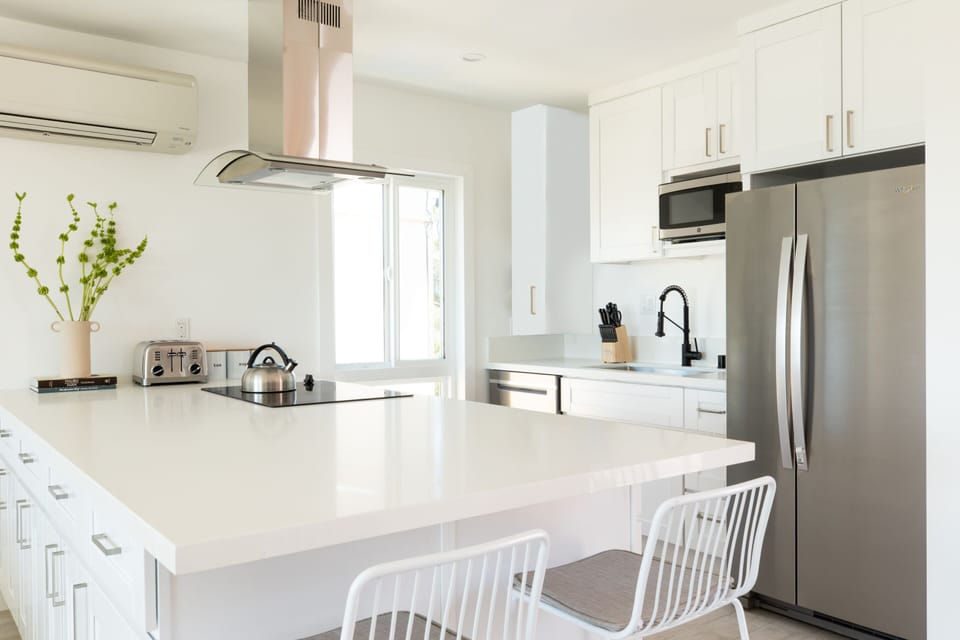 Kitchen feature modern appliances and a breakfast bar.