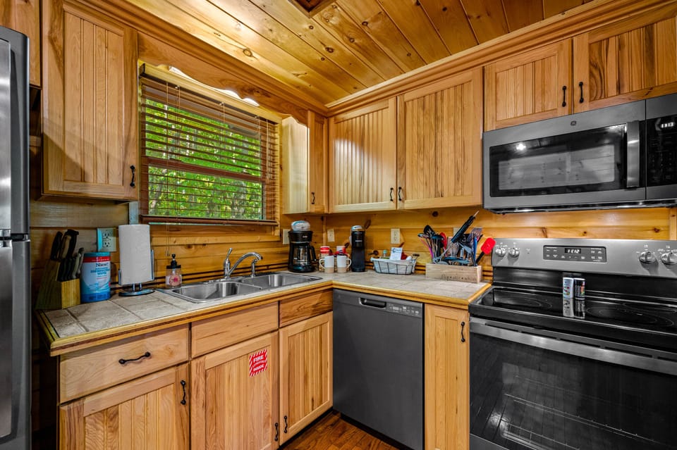 Fully stocked kitchen with new appliances and plenty of cookware.