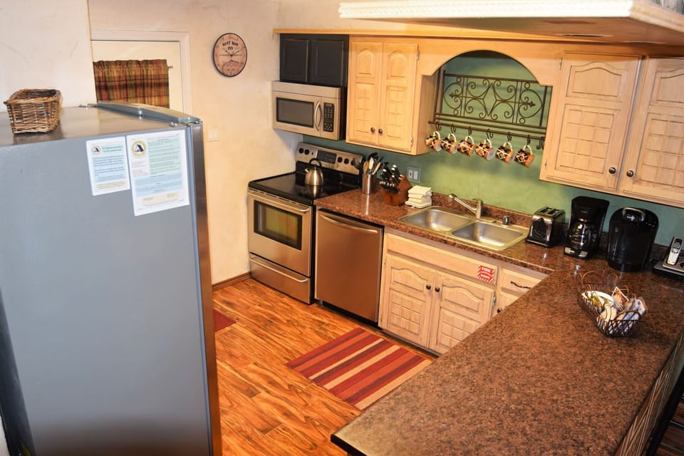 Your fully equipped kitchen awaits with stainless appliances, granite countertops, and a coffee maker ready for leisurely mornings. Cook, gather, and feel right at home in this warm, inviting space.