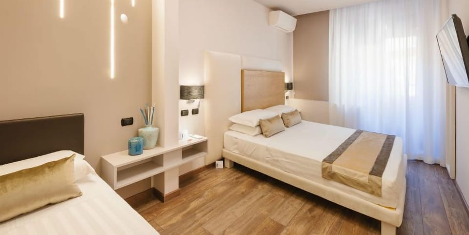 Deluxe Triple Room | Minibar, in-room safe, individually decorated, individually furnished