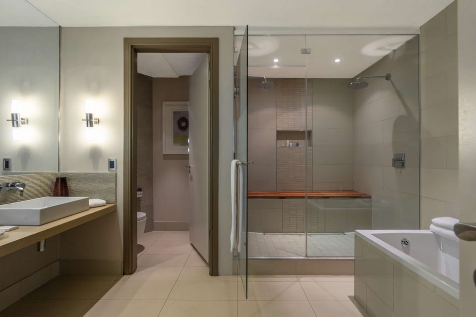 Suite | Bathroom | Separate tub and shower, rainfall showerhead, designer toiletries