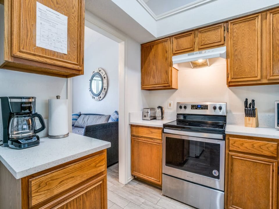 indoor, coffee and or coffee maker, kitchen, oven, stovetop, microwave.