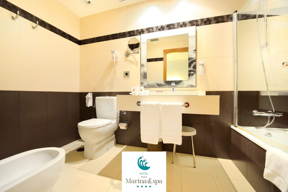 Bathtub, designer toiletries, hair dryer, bathrobes